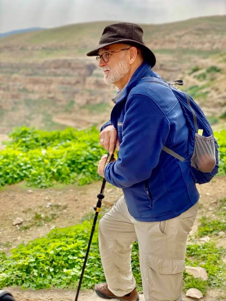 Pilgrim Jim Bimbi stands against walking stick in the Holy Land