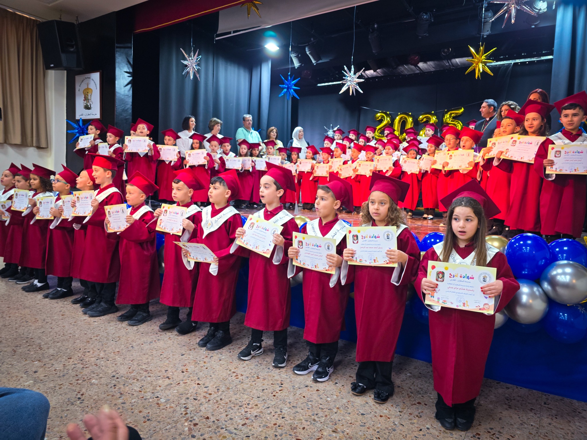 children stand at gradution from St. George's college
